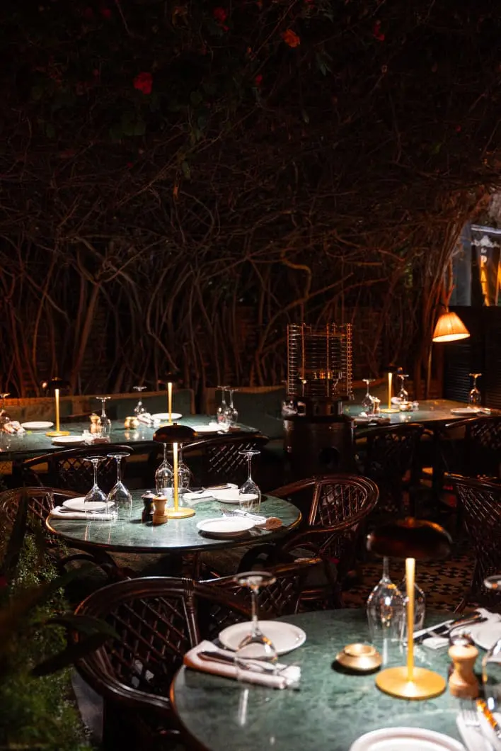 Open-air terrace dining beneath the trees at Le Palace Marrakech